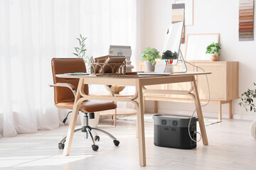 Graphic designer's workplace with computer and books in office