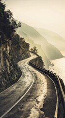 Winding road in the mountains on the sea coast. Misty morning.