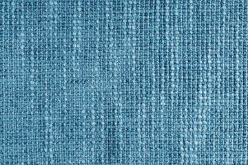 Jacquard woven coarse weave texture upholstery blue fabric. Textile background, furniture textile material, wallpaper, backdrop. Cloth structure close up, macro.