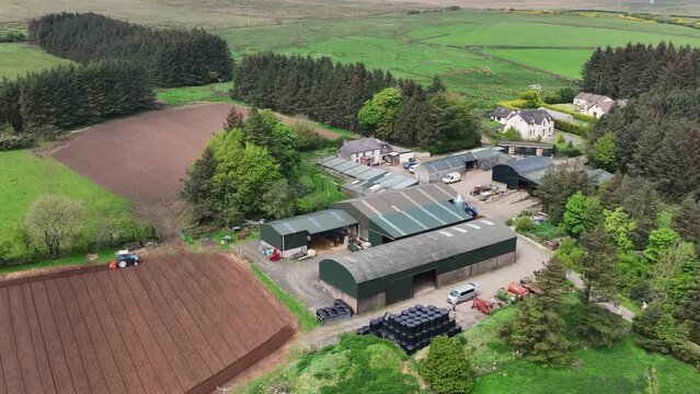 Aerial video of a Ford 6610 tractor rotovating a ploughed field for crops at Magill&rsquo;s farm Larne County Antrim Northern Ireland on 16-05-24