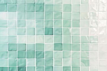 Green square tiles in a gradient from dark to light create a stunning textured background, perfect for modern interior design. The shiny surface adds a pop of color and symmetry to any space