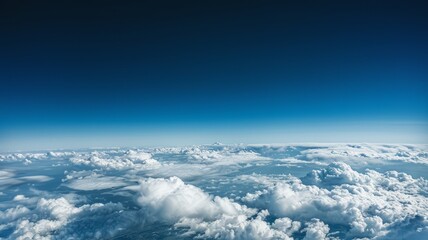Naklejka premium Serene View Above the Clouds with Endless Blue Sky and Horizon Line