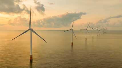 Windmill park with clouds and a blue sky, wind mill turbines in the ocean aerial view of a wind farm in the Ba Dong beach, Tra Vinh, Vietnam production clean energy © Hien Phung