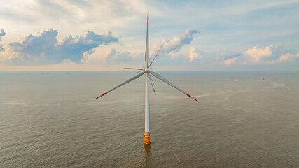 Windmill park with clouds and a blue sky, wind mill turbines in the ocean aerial view of a wind farm in the Ba Dong beach, Tra Vinh, Vietnam production clean energy
