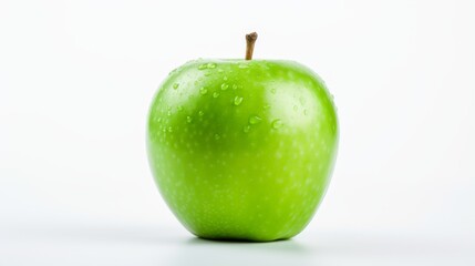 A fresh green apple with water drops vividly standing out on a white background, showcasing its freshness