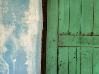 old blue painted cement wall and wooden window background.