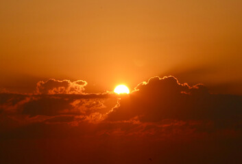 The golden sun rising above the clouds at dawn in Florida