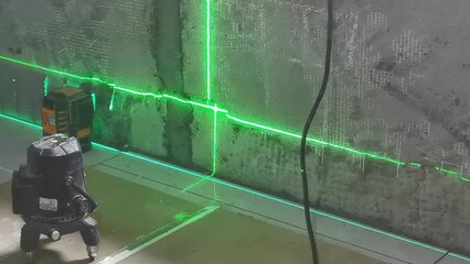 Interior decorator using laser level - Powered by Adobe