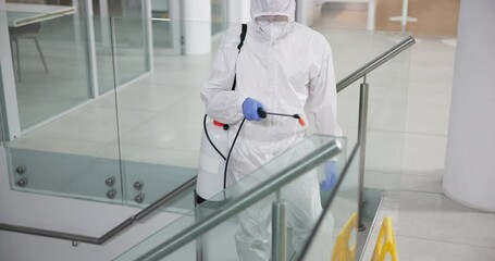 Man, hazmat suit and chemical for cleaning on stairs, pandemic and disinfection for bacteria. Male person, lockdown and spray for illness spread in office, sanitation and biohazard for virus safety