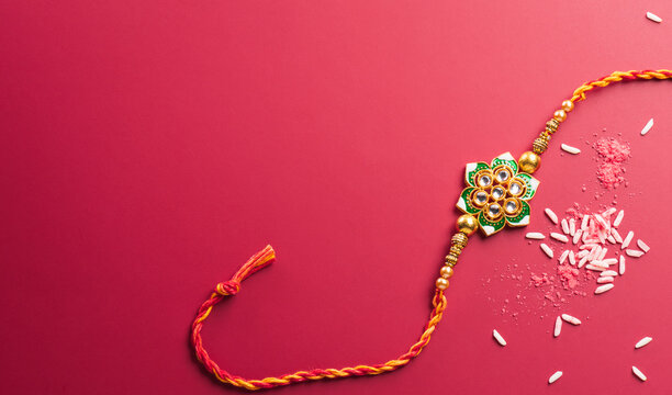 Raksha Bandhan, Indian festival with beautiful Rakhi and Rice Grains. A traditional Indian wrist band which is a symbol of love between Sisters and Brothers