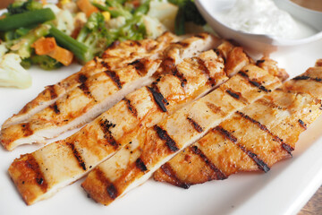 close up of grill chicken meat served with fresh vegetables on a plate 