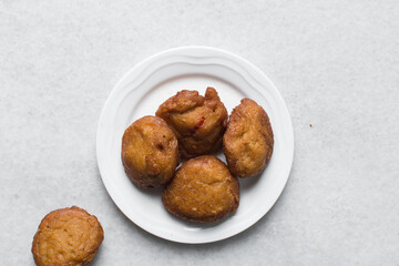 Overhead view of Akara on a white plate, top view of nigerian akara fried beans cake on a plate