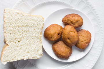 Akara and bread on a white plate, nigerian akara fried beans cake and bread on a plate