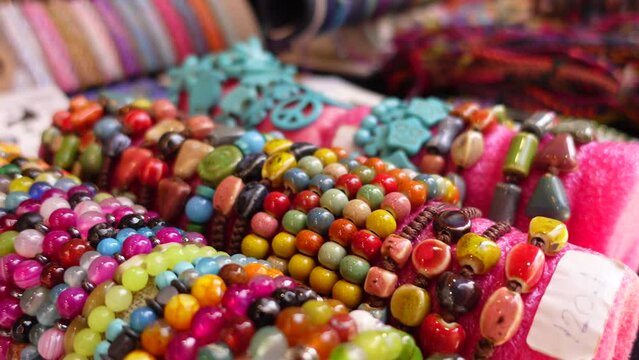  Bracelets with beads, laid out in the street market in the sun.