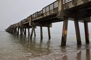 Boardwalk and pier on the beach across the ocean mid-morning. Jacksonville, Florida.