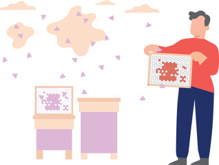 A boy is extracting honey from beeswax.