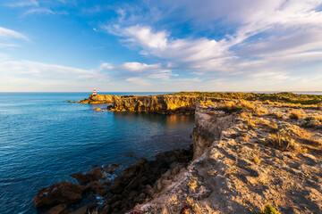 Robe Obelisk viewed along the rugged Limestone Coast with th eocean at sunrise, Guichen Bay, South...