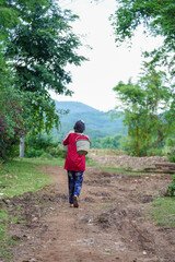 A Tai Lue girl is going to the garden.