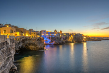 Fototapeta premium The cliffs of Polignano a Mare in Puglia, Italy, after sunset