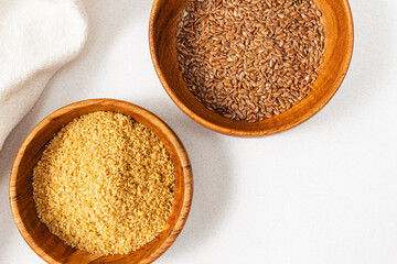 Flaxseed and flax meal in a wooden bowls, nutrient reach diet ingredients