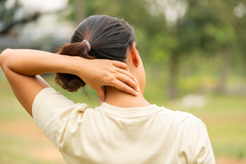 Women have neck pain, shoulder pain, at the park health concept