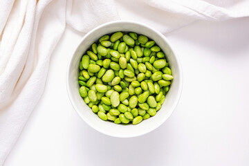 Green steamed soybeans, shelled edamame in a bowl, top view