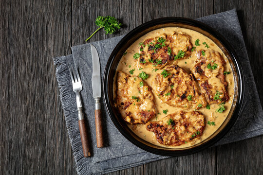 creamy smothered pork chops cooked in onion gravy