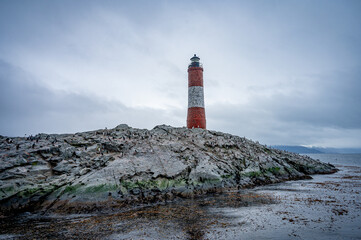Lighthouse end of world, Canal Beagle, Ushuaia, Argentina with penguins and sea 