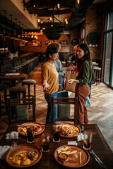 Rear view of a people walking out from the restaurant after a afternoon lunch