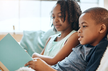 Obraz premium Boy, reading and book on sofa house for knowledge, bonding or learning literature, fantasy and language development. Family, girl and storytelling, education and information together of future growth