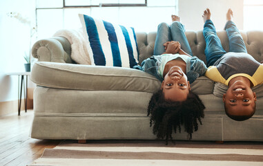 Upside down, portrait and kids on couch, happiness and playing indoors weekend break, cheerful and...