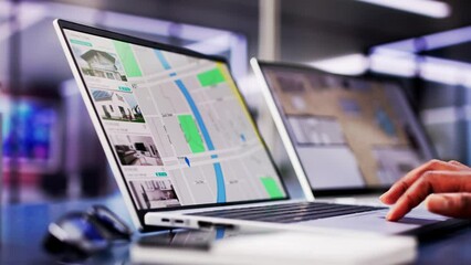 African woman using laptop to search online real estate property listings