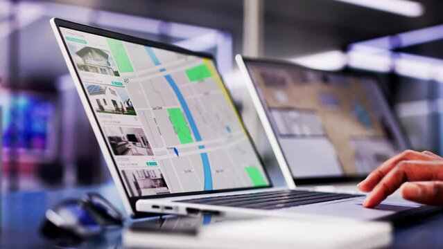 African woman using laptop to search online real estate property listings