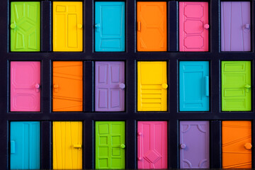 Vibrant grid pattern of colorful toy door collection in various shade and design creating a playful and cheerful visual as a way of entrance to dream or career path