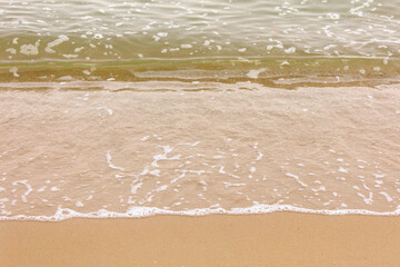 Yellow sand on the seashore as an abstract background. Texture