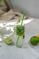 Summer refreshing mojito mocktail drink on table with natural aesthetic sunlight shadows