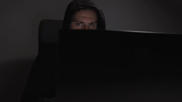 Hacker, man with laptop, dangerous guy, violent actions, criminal network.