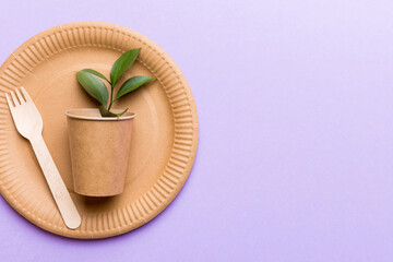 set of empty reusable disposable eco-friendly plates, cups, utensils on light white colored table background. top view. Biodegradable craft dishes. Recycling concept. Close-up