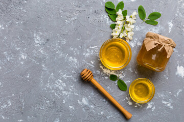 honey jar with acacia flowers and leaves. fresh honey top view flat lay