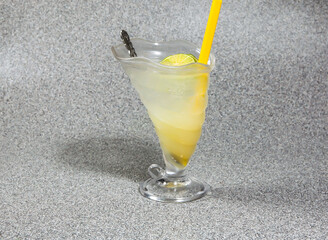 Thai Style Ice Lime Soda with straw served in glass isolated on grey background side view of hong kong dessert drink