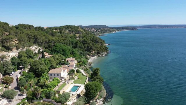 Aerial view drone video flying from the air over the picturesque sea coast of the south of France, Provence, Istres at bright sunny summer day