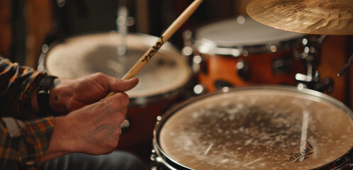 Fototapeta premium Drummer’s Hands Using Sticks on Drum Kit