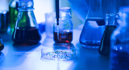 Team of biochemical research scientists working with a microscope for vaccine development in pharmaceutical research labeling.