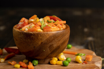 a mixture of quick-frozen corn, peas, peppers, and carrots