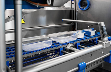 Automatic food sealing machine line with empty eco-friendly plastic containers. packaging machineries for Ready-to-eat meals.