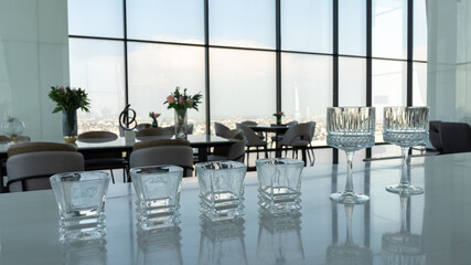 Many empty glass on counter at rooftop bar.