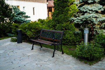 In a serene park, a wooden bench is nestled amidst lush trees, providing a tranquil spot for reflection and unwinding in the midst of natures beauty. The setting is peaceful and harmonious