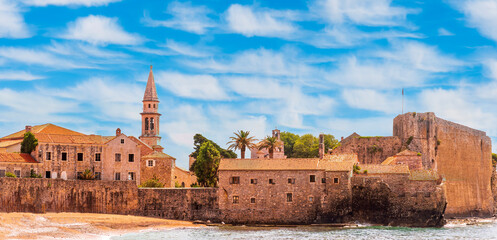 picturesque seascape of beautiful isle Sveti Stefan near Budva Montenegro. Scenic orange buildings...
