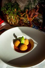 meatballs served on a dish in restaurant with natural light 
