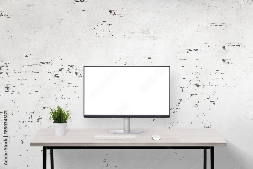 Poster Computer display mockup on a clean work desk with a rough wall background. Ideal for showcasing digital designs in a minimalist and textured office environment